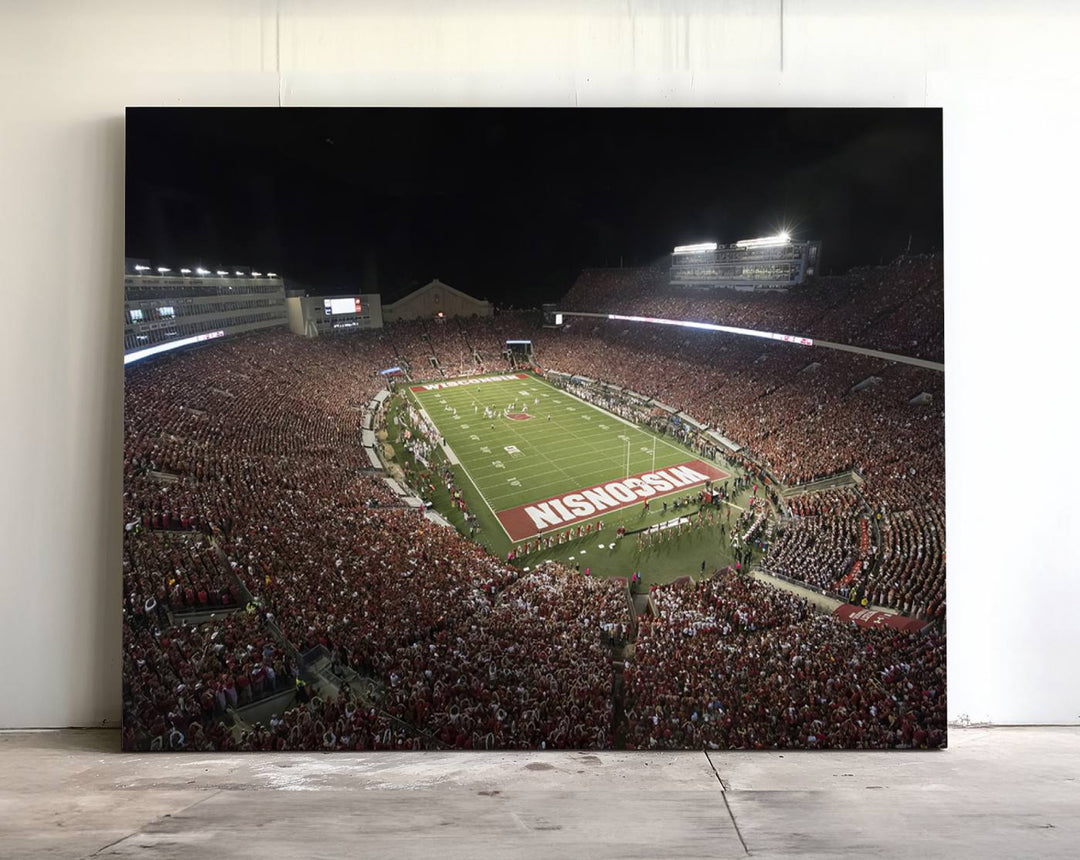 A painting of a stadium packed for a Wisconsin Badgers game, with WISCONSIN clearly visible in the end zone at Camp Randall Stadium.