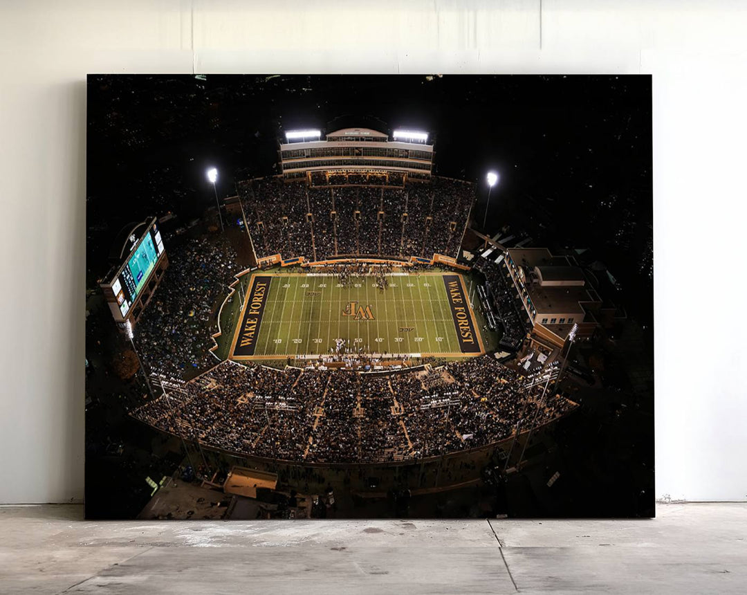 Canvas wall art displays an aerial view of Wake Forest Demon Deacons stadium at night.