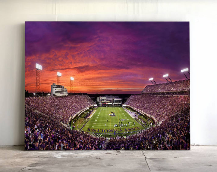 A sunset over Dowdy-Ficklen Stadium, Greenville, captured on museum quality canvas with vibrant purple and orange skies.