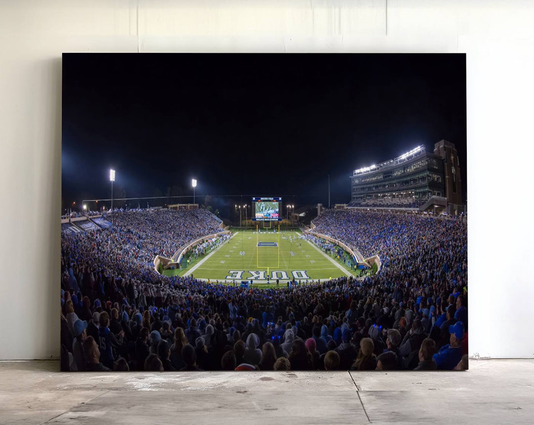 Under bright lights at night, the Duke Blue Devils Football Team Durham canvas wall art print is prominently displayed.