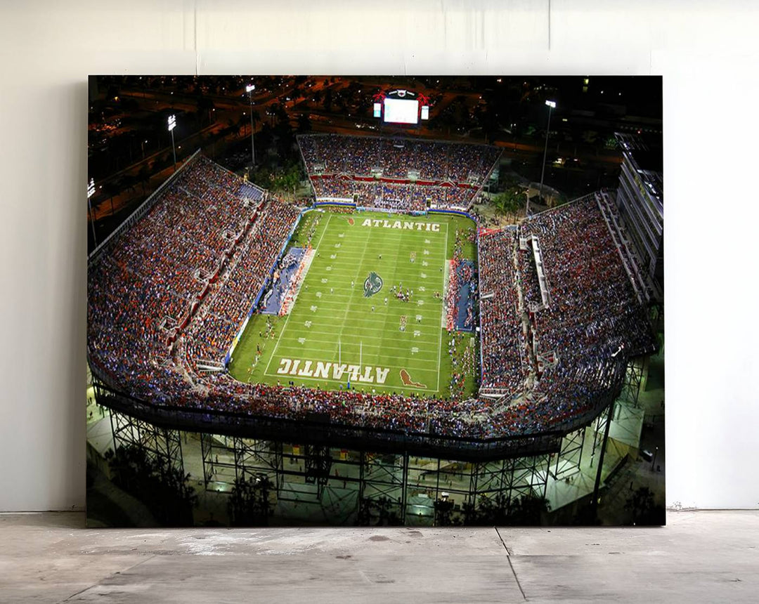 Gallery-quality wall art complements the view of the FAU Stadium with Florida Atlantic University Owls on the field in a night aerial setting.