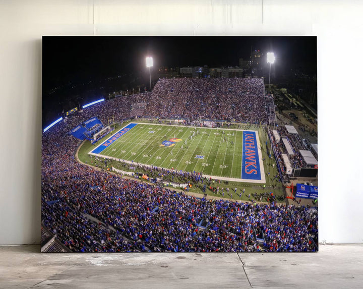 A canvas depicting an aerial view of the University of Kansas Memorial Stadium, showcasing bright lights and a lush green field at night.