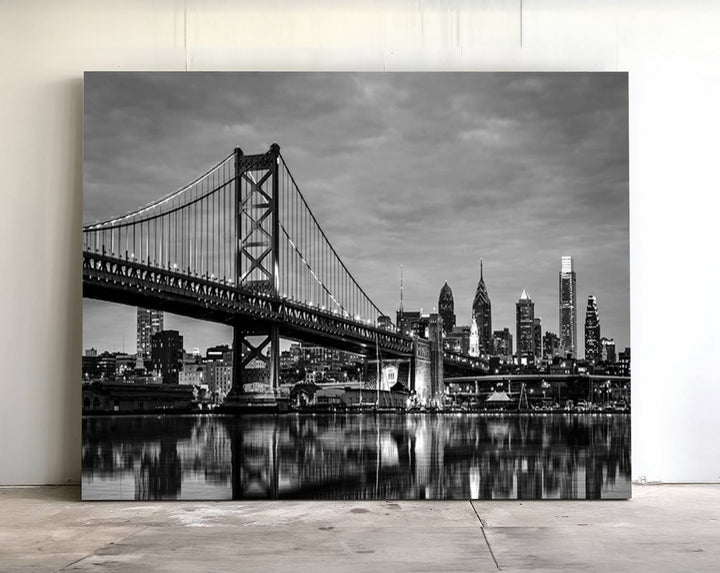 The "Large Wall Art Philadelphia Canvas Print" showcases a black-and-white depiction of the Ben Franklin Bridge with a water reflection.