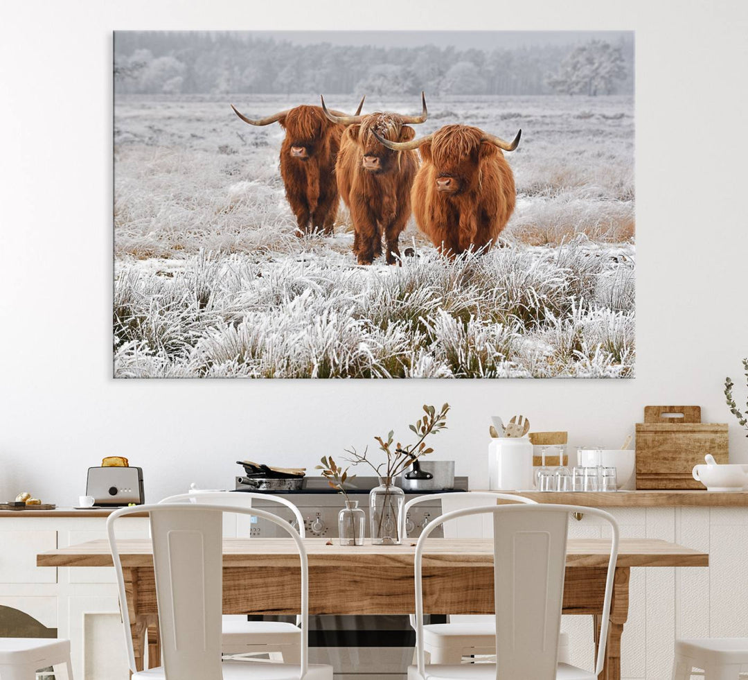 The Highland Cows in Snow canvas showcases three cattle in a frosty field.