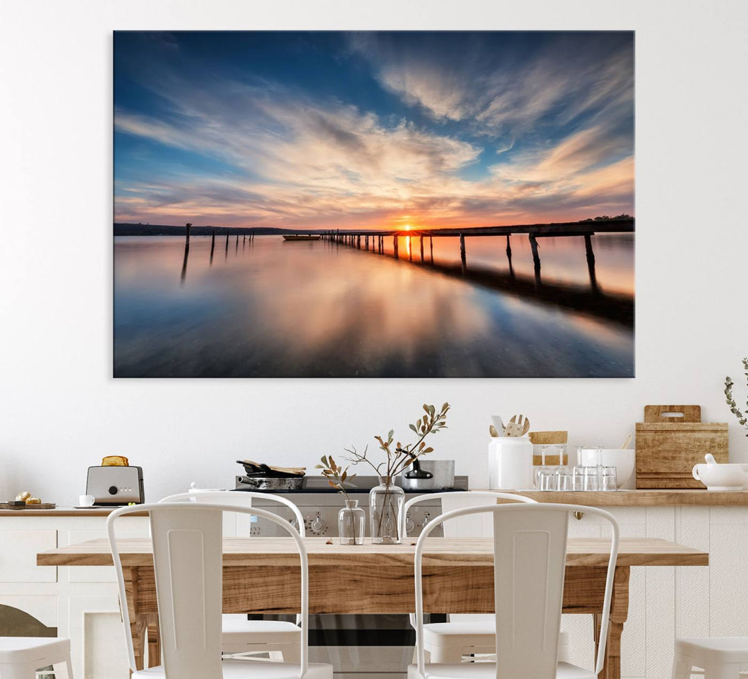 The Sunset Pier Canvas features a serene coastal landscape with vibrant hues under cloudy skies, ideal for modern decor.