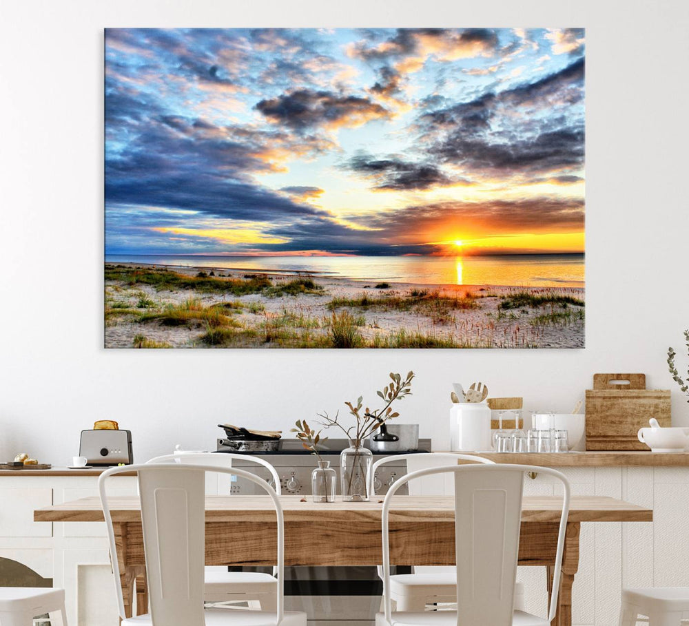 The Sunset On The Ocean canvas wall art features a beautiful beach sunset with grass and clouds.