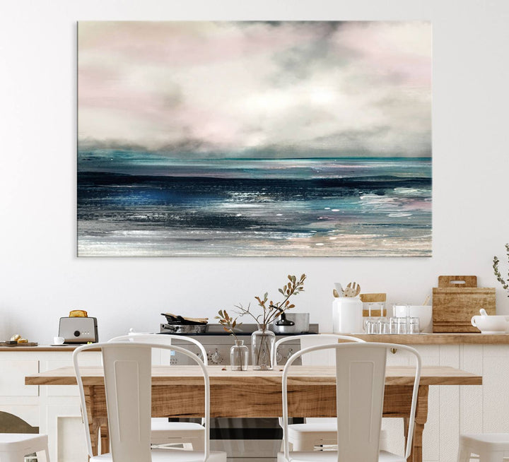 A contemporary abstract wall art canvas print in pastel pink, teal, and gray tones hangs on the wall.