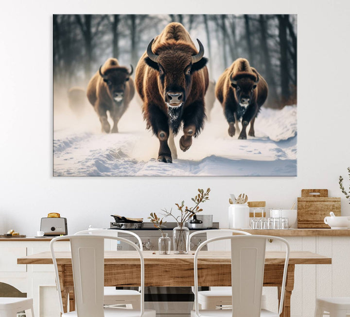 Wall art titled Cow Bighorn shows three bison running through snow in a forest.