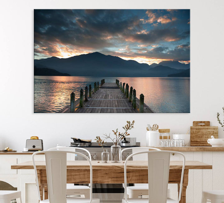 The Mountain Lake Wood Pier Canvas Wall Art depicts a serene lake and mountains, enhancing the beauty of any space.