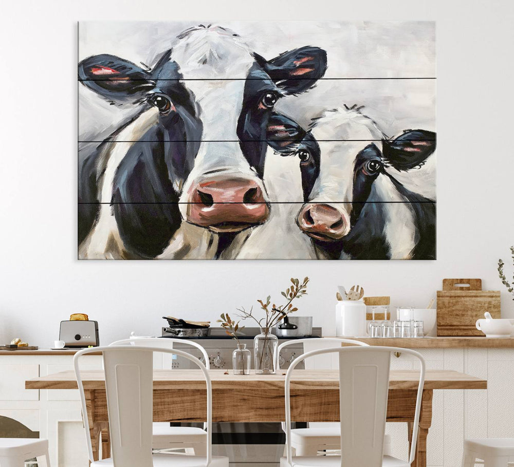 The Vintage Baby and Mom Cattle Canvas, featuring cows with black and white patches, is a prominent piece of wall art.