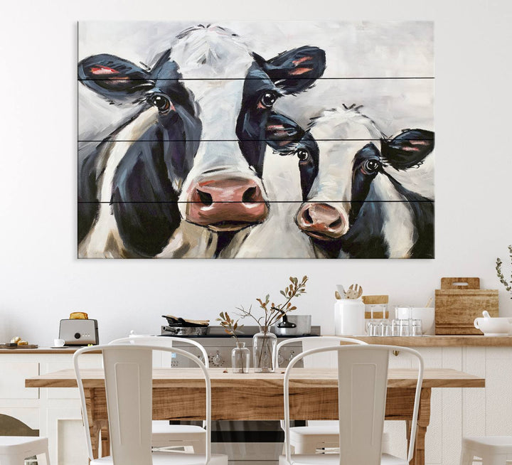 The Vintage Baby and Mom Cattle Canvas, featuring cows with black and white patches, is a prominent piece of wall art.