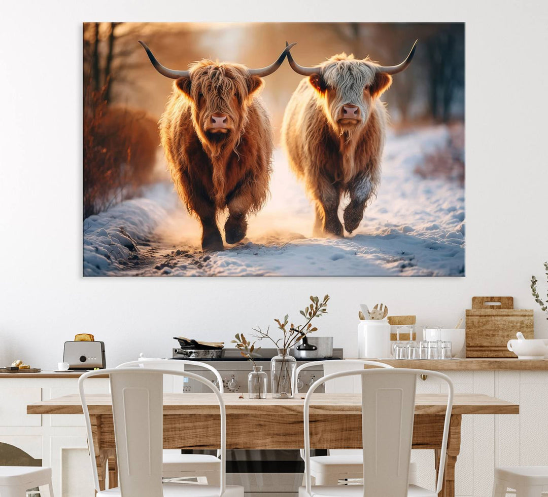 The wall art is a Scottish Highland Cow Horn canvas print featuring cows on a snowy path bathed in warm sunlight, serving as a rustic decor piece.