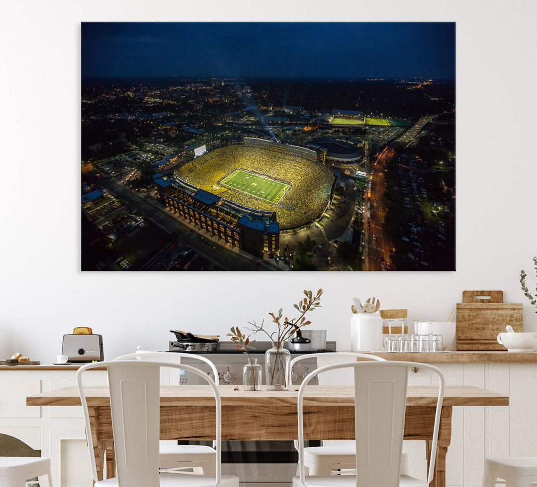 Aerial view of Michigan Stadium at night, surrounded by city lights, depicted on a Michigan Wolverines wall art canvas print.