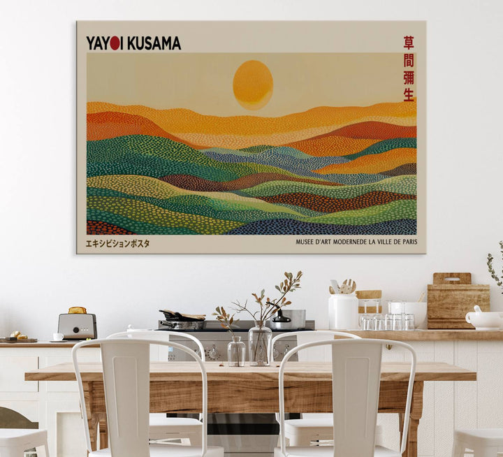 A framed Yayoi Kusama 1986 wall art print showcases a vibrant abstract landscape with colorful, wavy dots and a sun above the horizon.