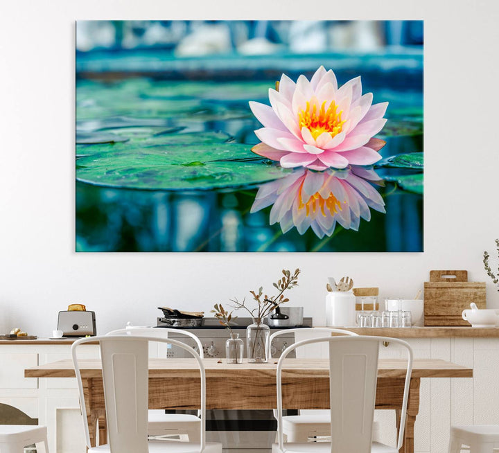 The Lotus Flower Canvas Print showcases a pink water lily with a yellow center gracefully floating on a calm pond.