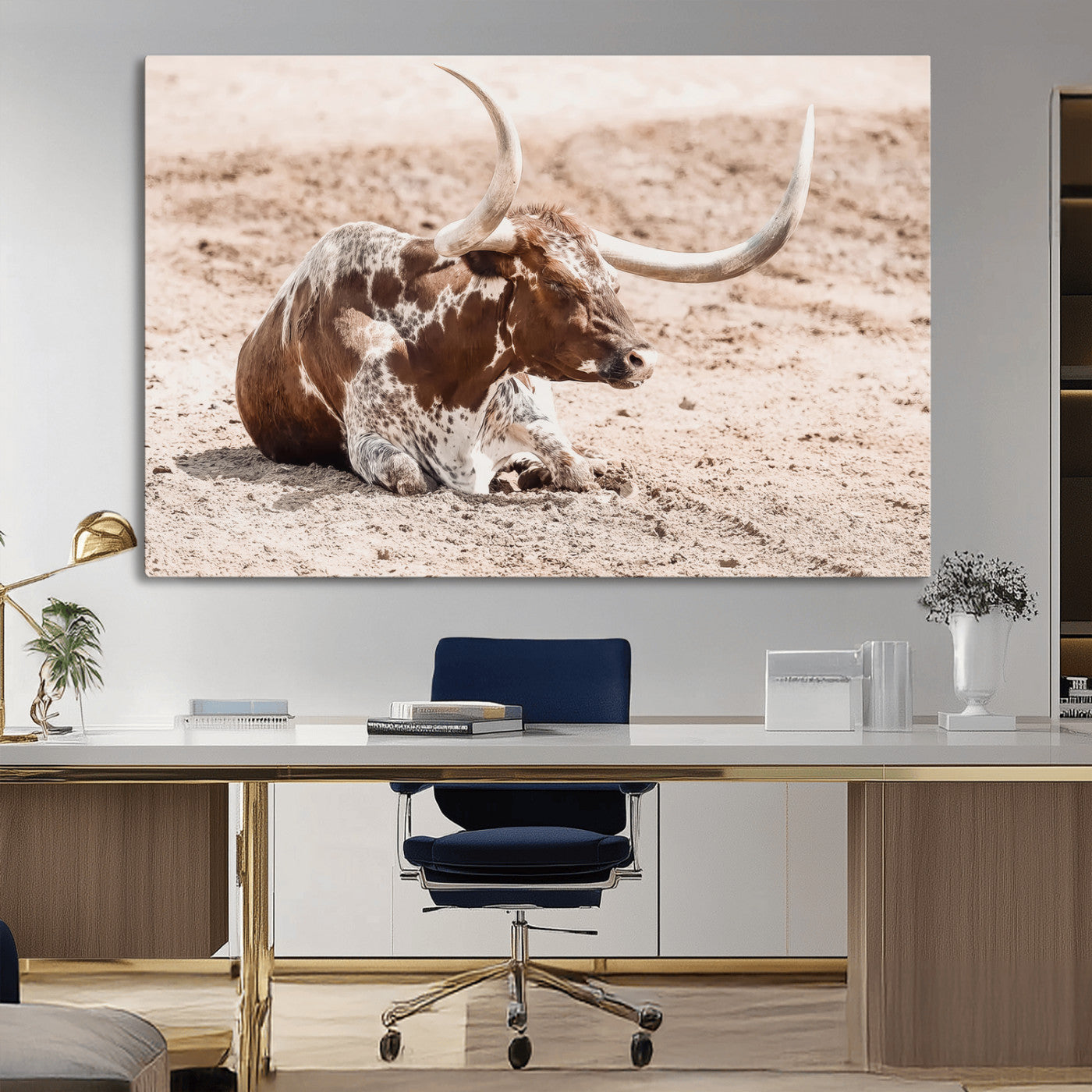Texas Longhorn bull resting on dusty ground with warm tones, ideal for rustic western or farmhouse-themed wall decor.