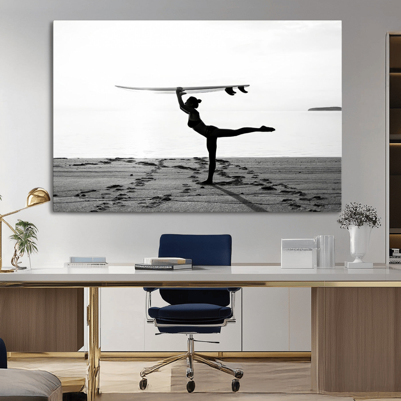 A woman balances a surfboard on her head while striking a yoga pose on the beach, silhouetted against a calm ocean horizon.