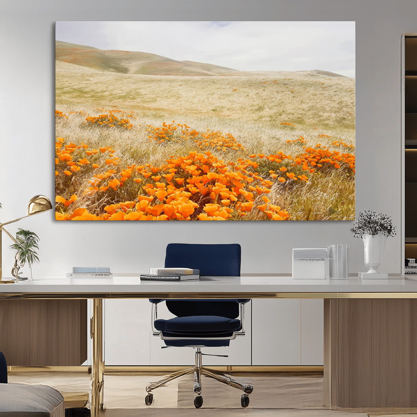 A golden field with vibrant orange poppies blooming across rolling hills under a soft, sunlit sky, creating a warm and rustic landscape.