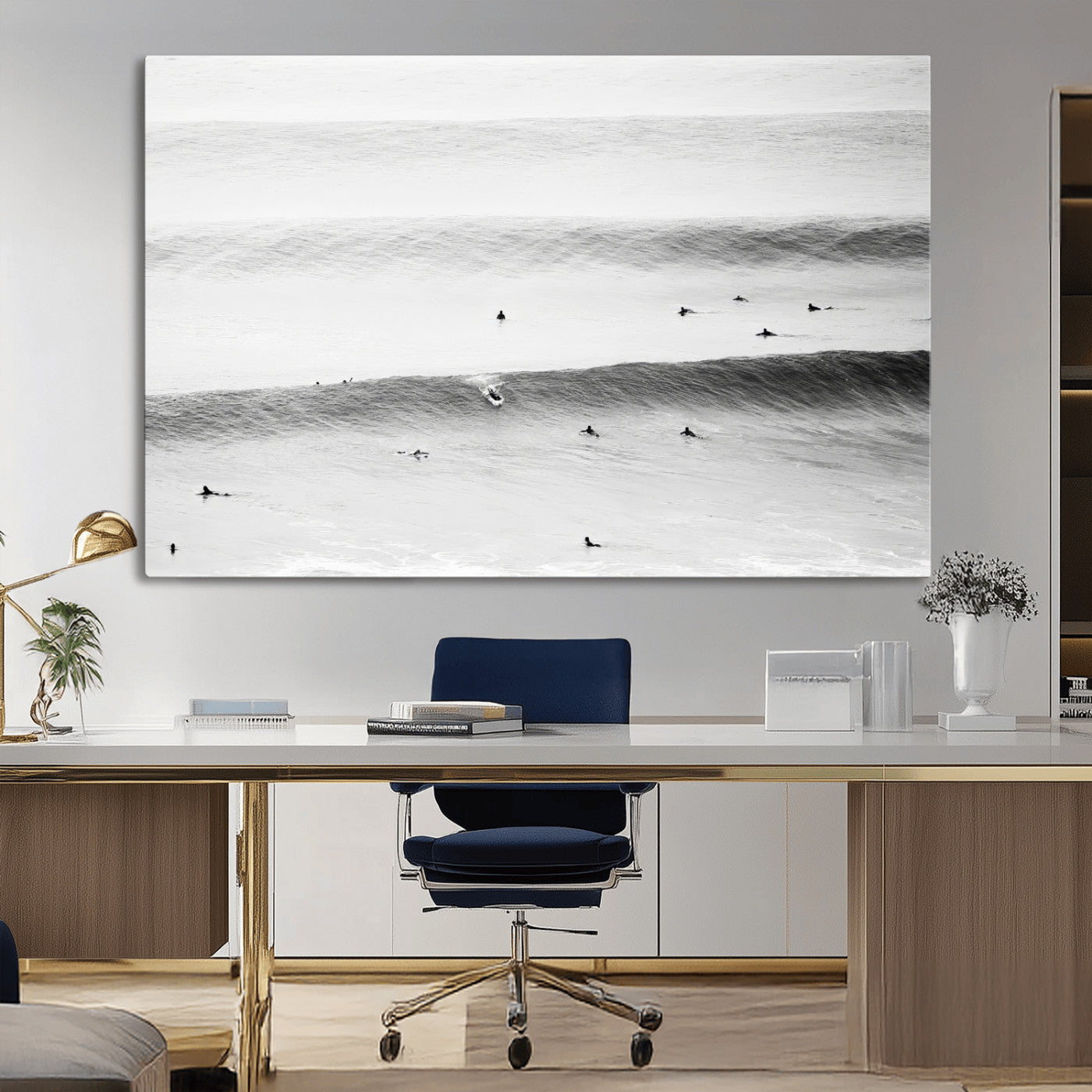 A monochrome photograph of swimmers gliding through gentle ocean waves, evoking a sense of calm and movement.