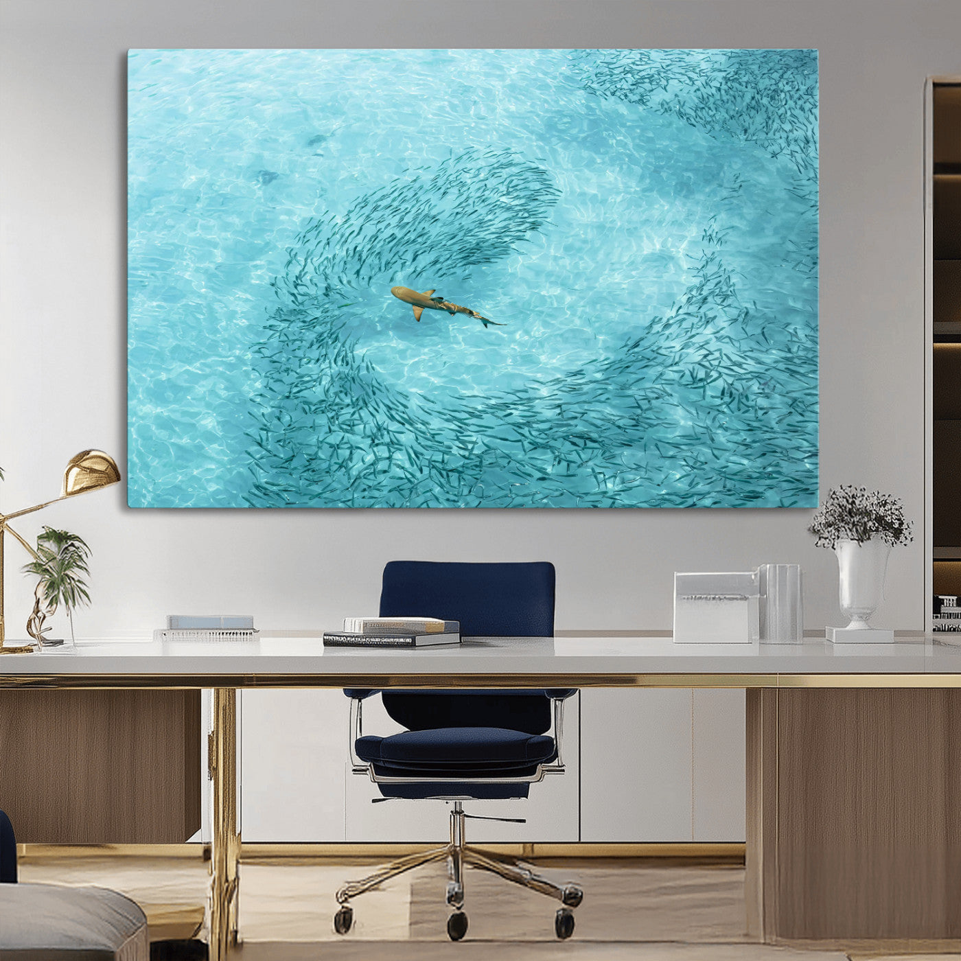 Aerial view of a shark swimming through a swirl of fish in clear turquoise waters, perfect for calm coastal or beach house decor.