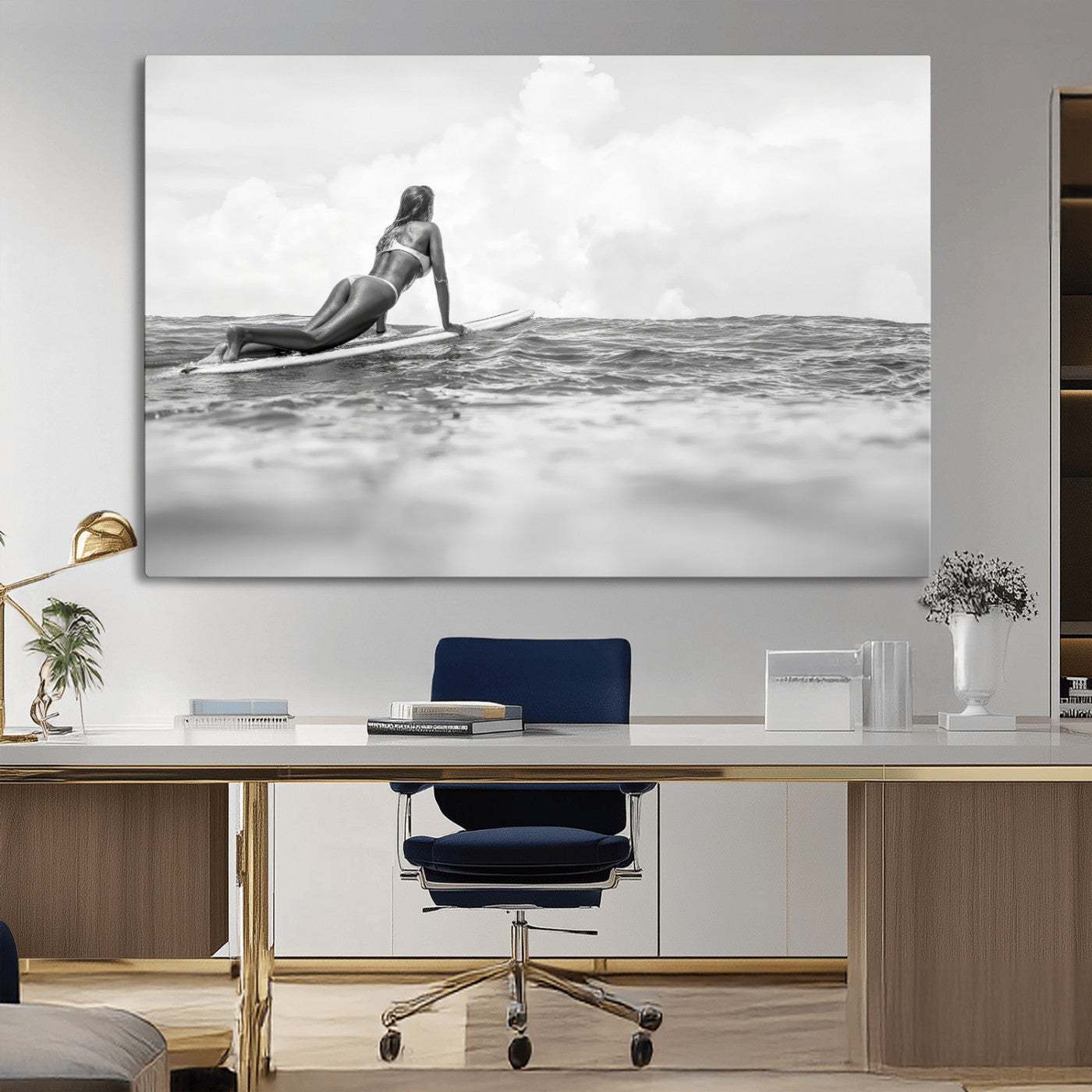 A black and white ocean scene featuring a surfer girl waiting on her board, gazing at the horizon, capturing a tranquil and adventurous coastal moment.