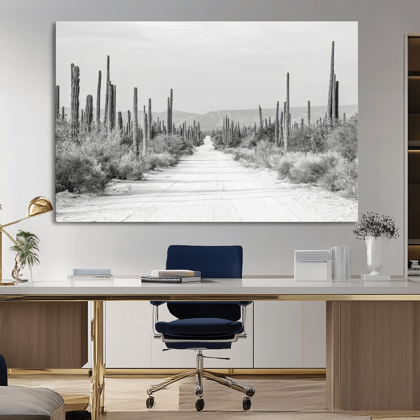 A black and white desert road stretching through a cactus-filled landscape, creating a rugged and timeless southwestern aesthetic with a sense of adventure.