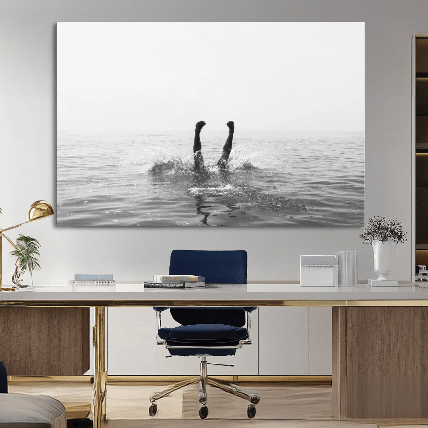 A black and white minimalist water scene capturing a playful splash as a swimmer dives upside down, creating a carefree and artistic aquatic aesthetic.