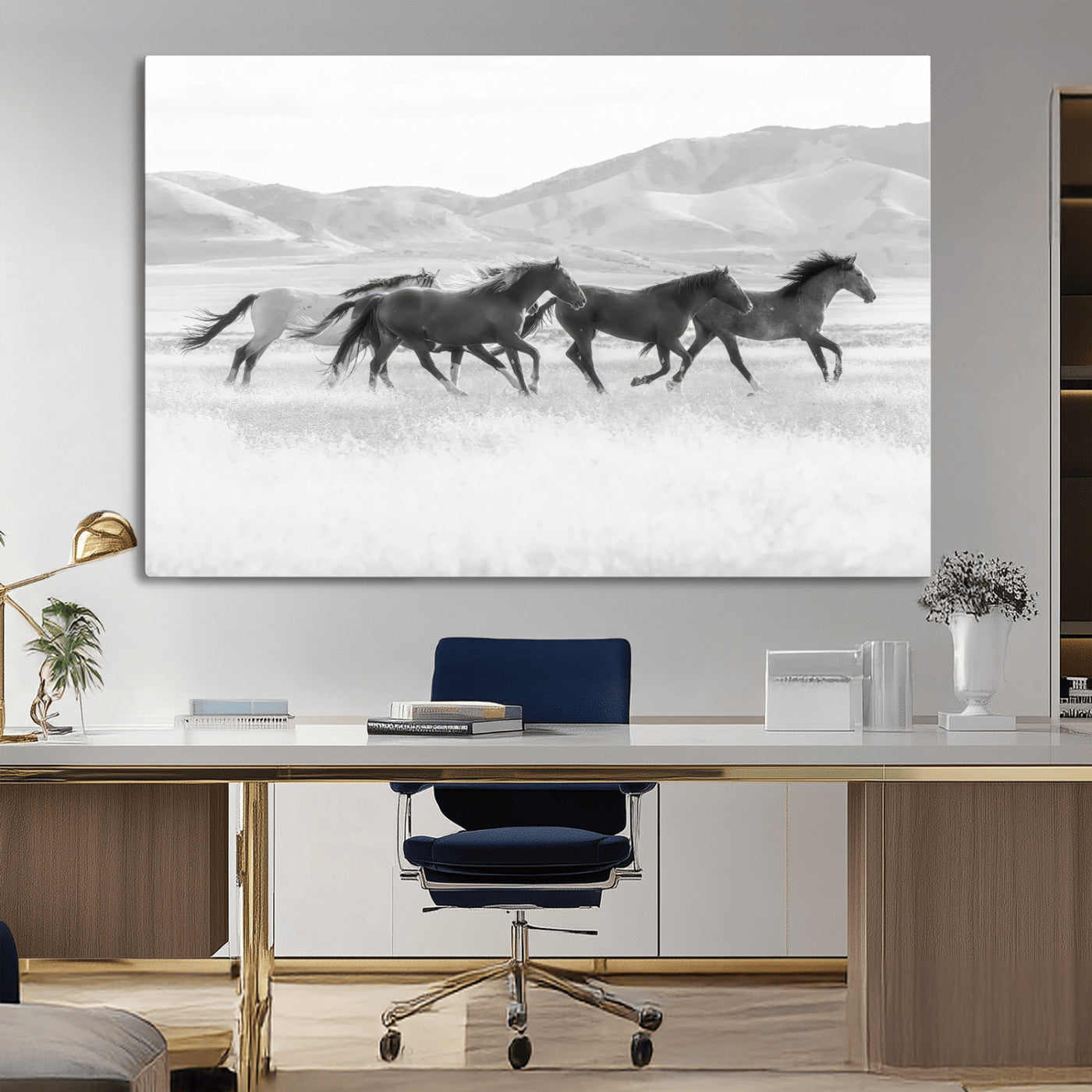 A black and white image of wild horses running freely across an open grassland, capturing the power and beauty of untamed nature in a rustic western setting.