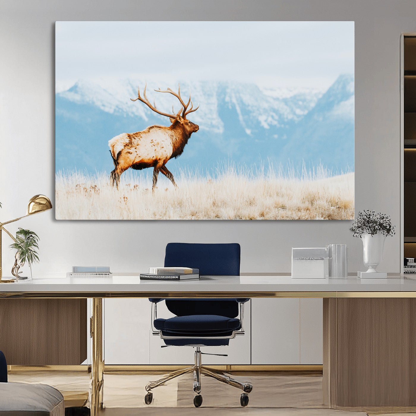 Majestic elk standing on dry grassland with snowy mountains in the background, ideal for rustic or lodge-inspired wall decor.