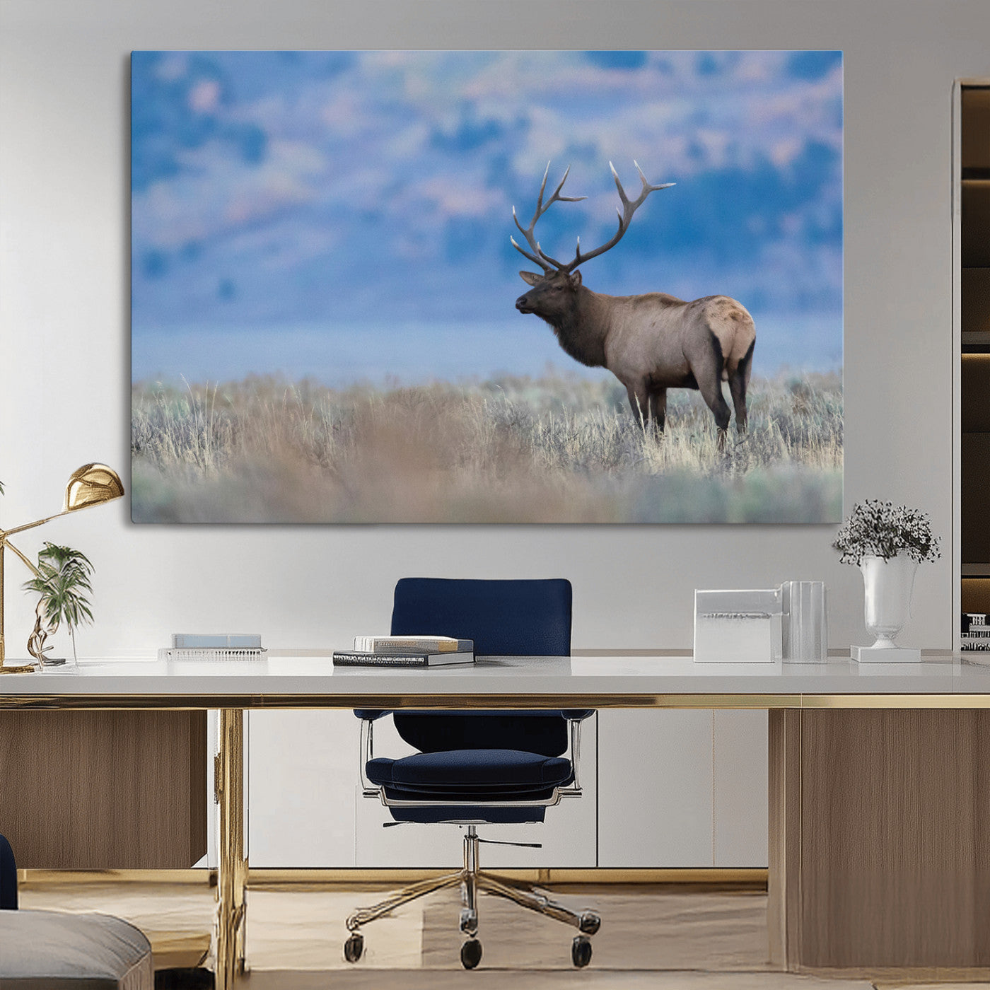 Elk with large antlers standing in open field, mountains blurred in background, perfect for rustic cabin or lodge-style decor.