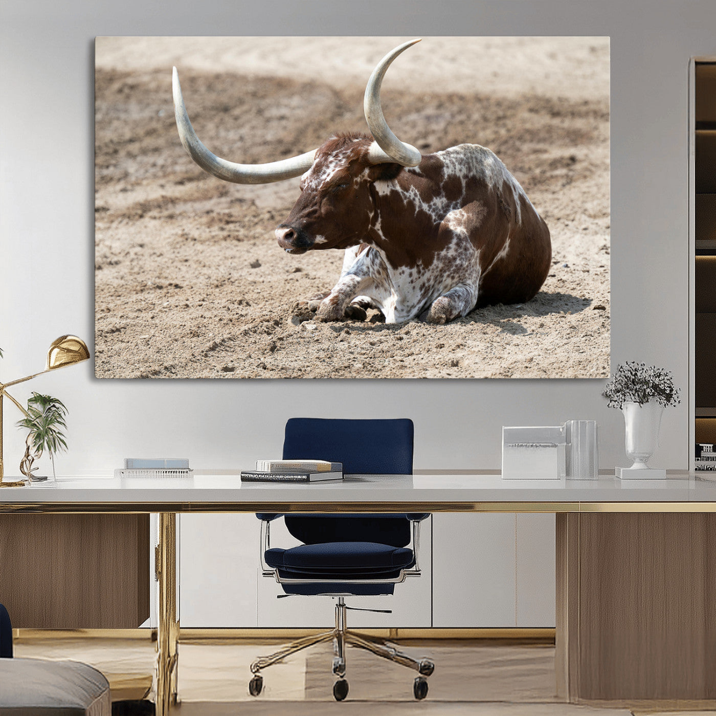Texas Longhorn resting on sandy ground with large curved horns, capturing a rustic Western aesthetic perfect for farmhouse-style wall art.