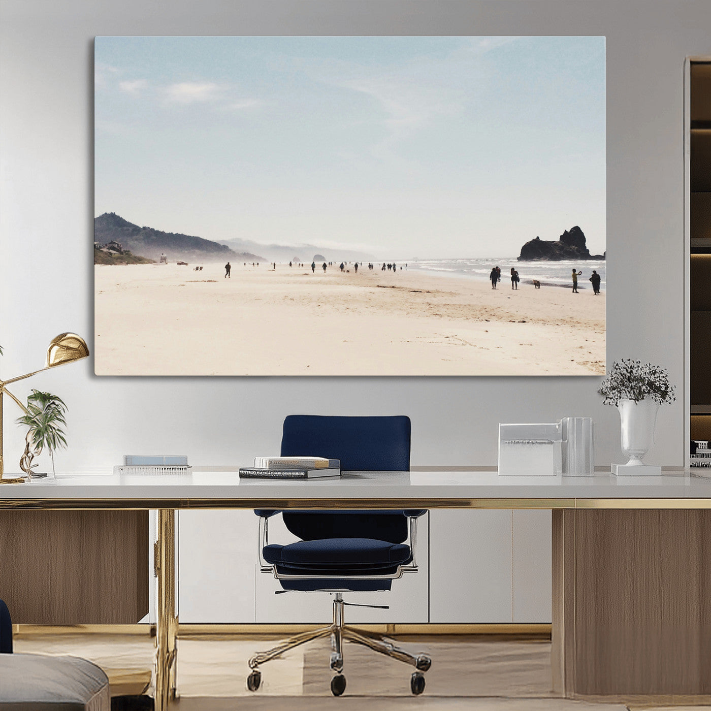 A serene beach with soft sand, misty mountains, and scattered people walking along the shoreline, creating a peaceful coastal landscape.