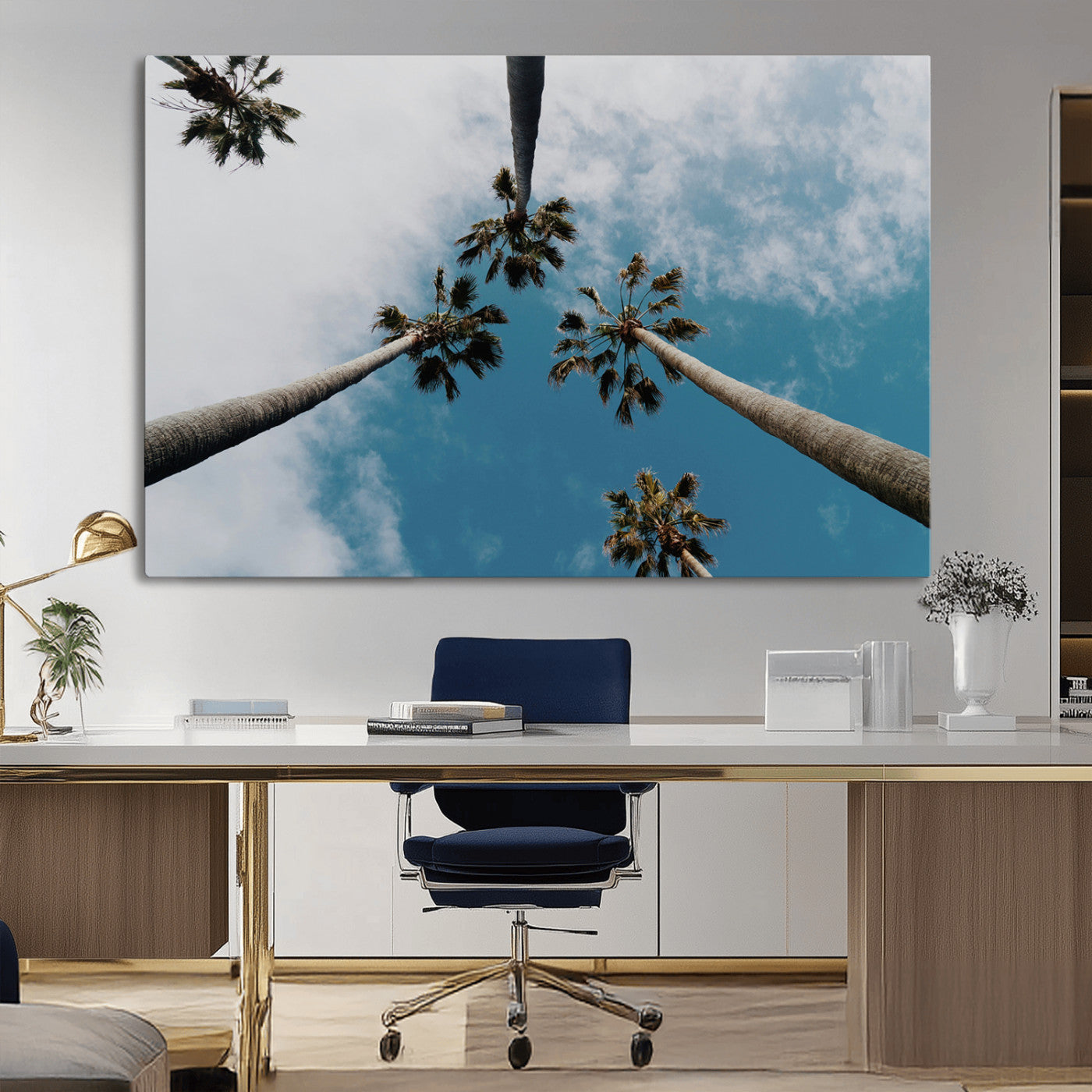 Looking up at tall palm trees against a bright blue sky with scattered clouds, creating a tropical and airy atmosphere for modern home decor.