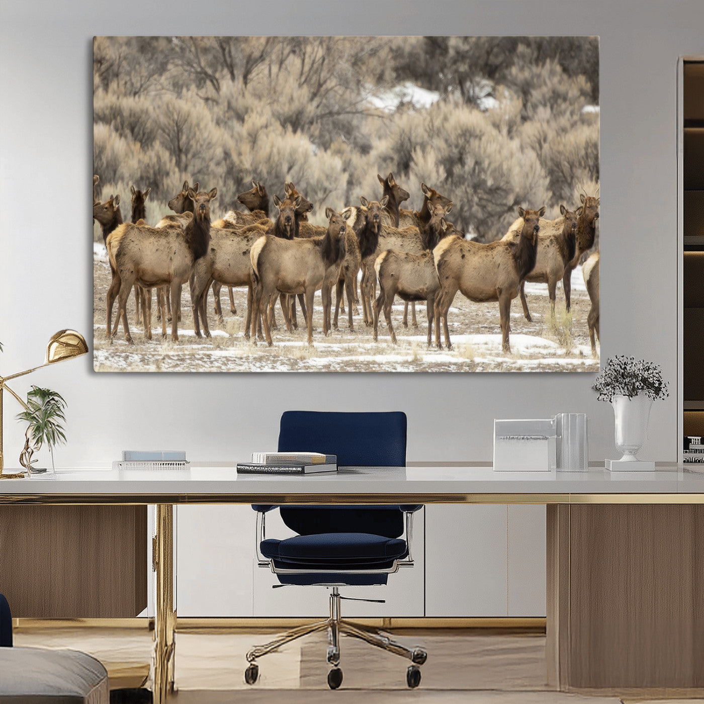 A stunning wall art canvas print featuring a large herd of elk standing together in a natural winter landscape with muted earthy tones and soft background foliage, perfect for rustic or nature-inspired home decor.