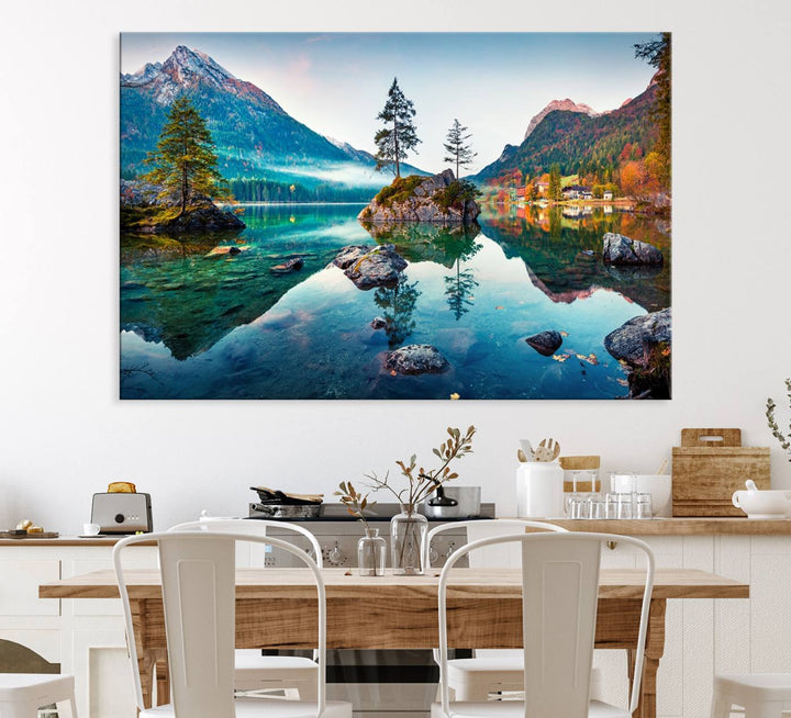 The 3-panel wall art showcases a serene mountain lake with rocky islands and trees, creating an ideal focal point for dining rooms or offices.