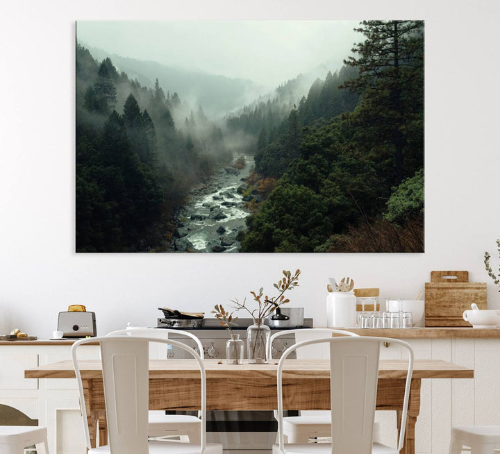 The Misty Forest Wall Art features a serene landscape with a misty river and evergreens, ideal for enhancing the ambiance of any living room or cabin.