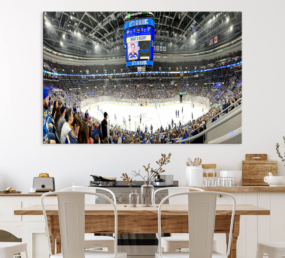 Wall art prints depicting the bustling scenes of the St. Louis Blues being cheered on by a full house at the Enterprise Center, beneath a large scoreboard.