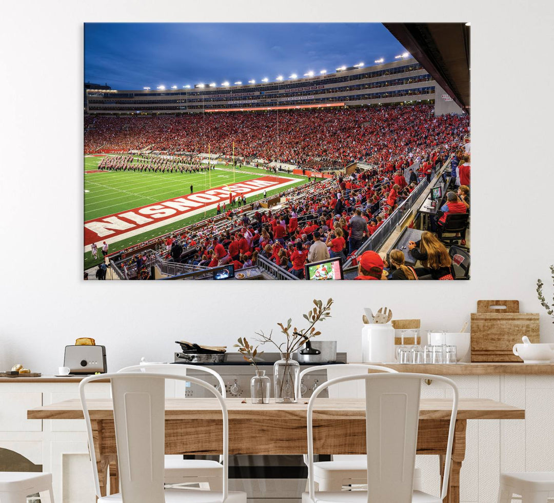 A vibrant wall art captures the essence of Madison Camp Randall Stadium, depicting a sea of fans in red and white during a Wisconsin Badgers football game under bright lights.