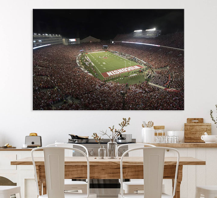 A painting of a stadium packed for a Wisconsin Badgers game, with WISCONSIN clearly visible in the end zone at Camp Randall Stadium.