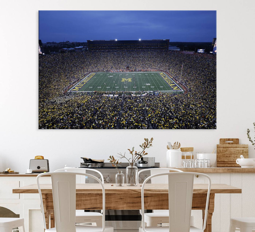 Wall art featuring an aerial shot of Michigan Stadium at dusk, showcasing the University of Michigan Wolverines M logo.