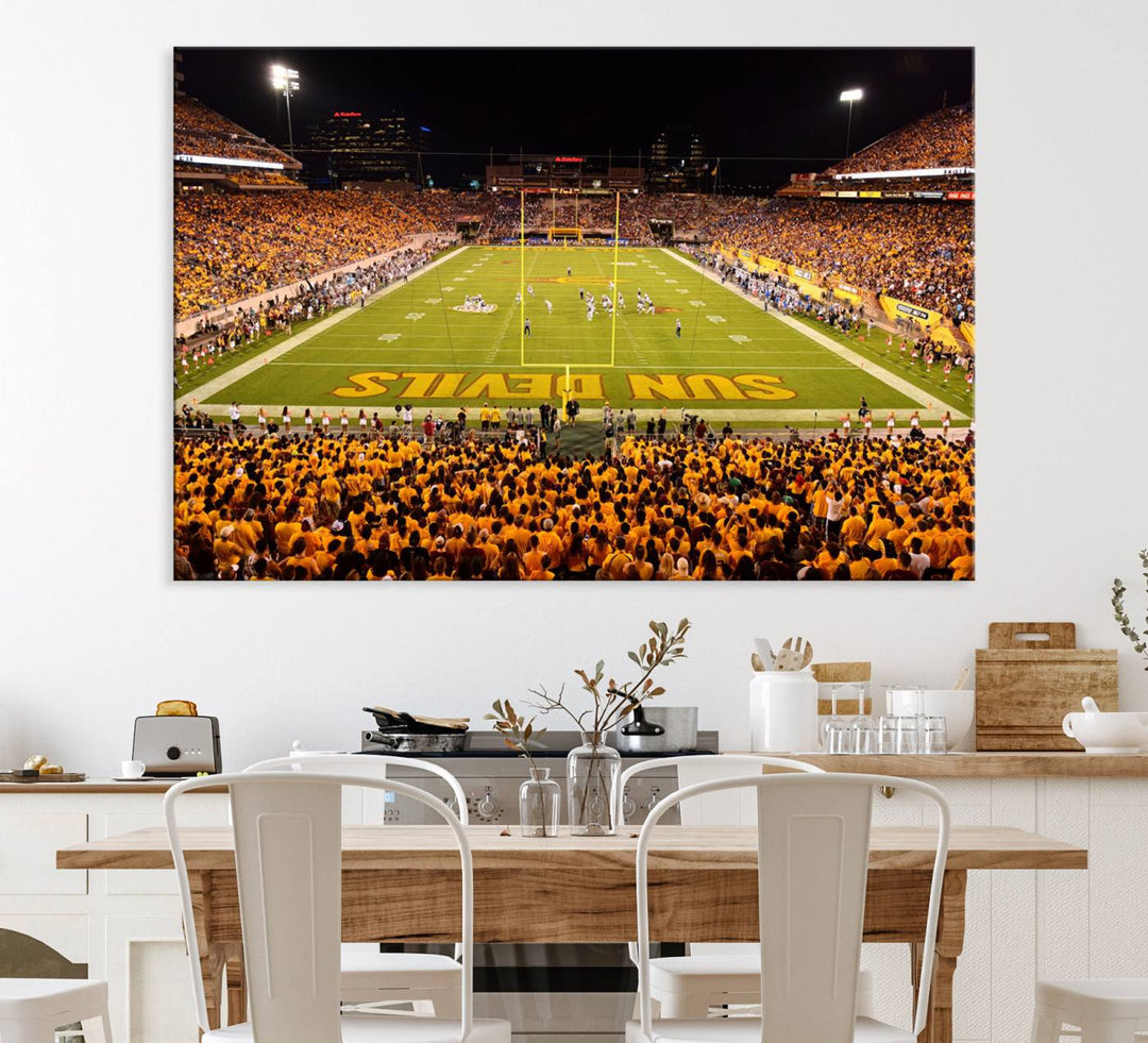 The Phoenix Stadium Canvas Wall Art features a vibrant depiction of a packed stadium filled with ASU Sun Devils fans wearing yellow shirts.