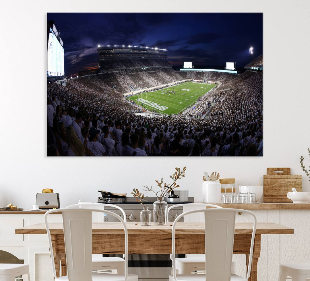 A packed football stadium at night, with bright lights and fans in white, depicted in a Michigan State Spartans Stadium wall art.