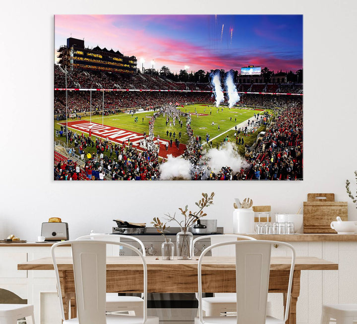 The wall art features a canvas print of the Stanford Cardinal football team, capturing players, fireworks, and smoke against the backdrop of a sunset at Stanford Stadium.