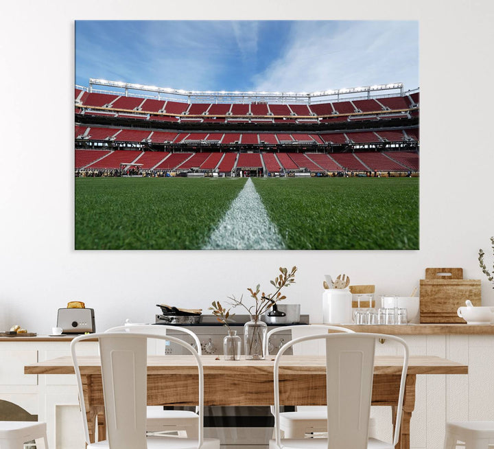 A canvas print of the University of Tulsa Golden Hurricane showcases H.A. Chapman Stadiums football field and red seats against a backdrop of a blue sky.