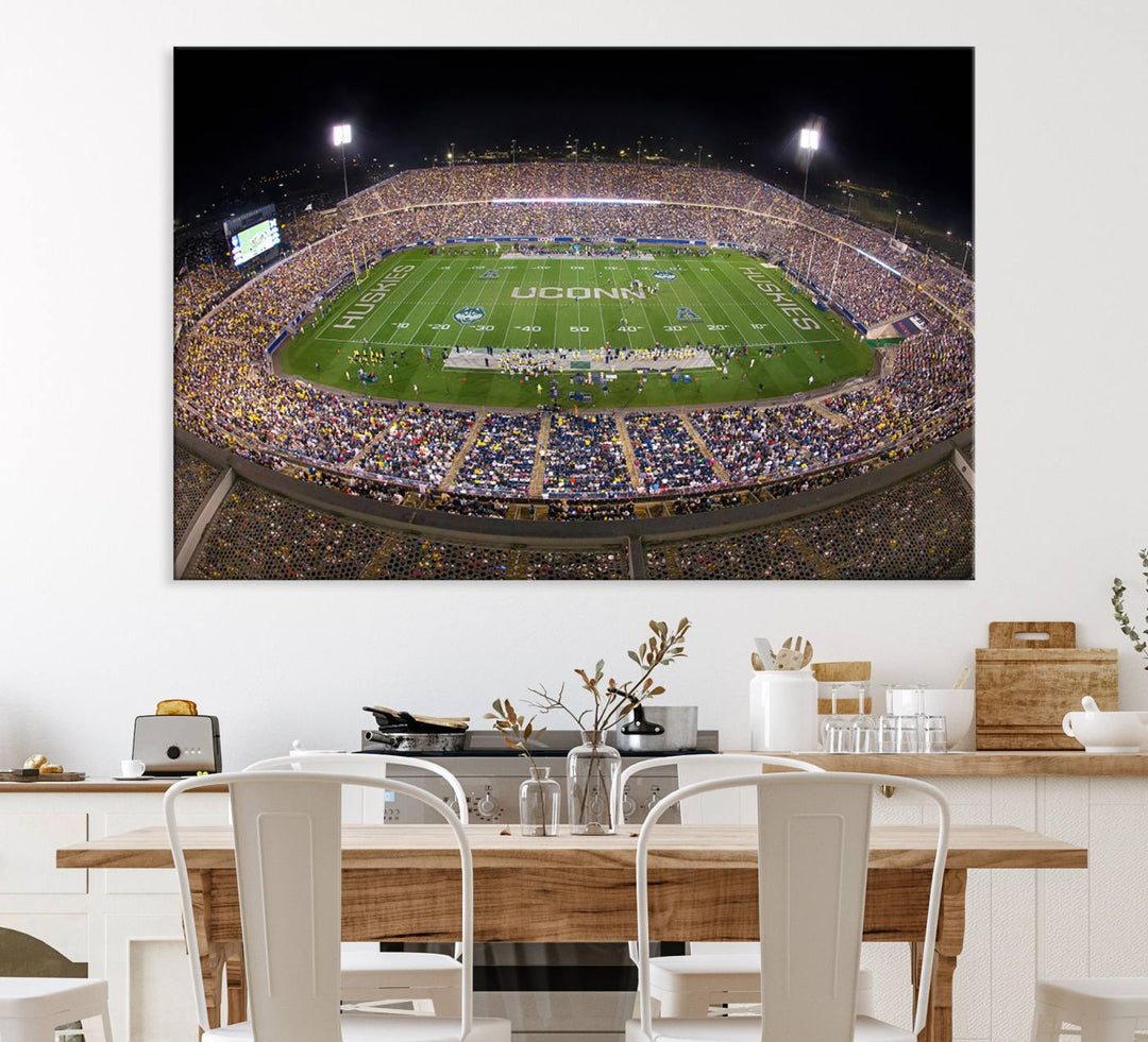 A large football stadium at night, featuring the UCONN Huskies, is depicted on the East Hartford Pratt & Whitney Stadium Wall Art Canvas Print.