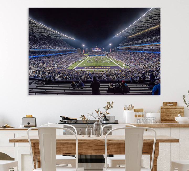 A canvas print titled The University of Washington Huskies Football depicts a packed Husky Stadium at night, as seen from the stands.