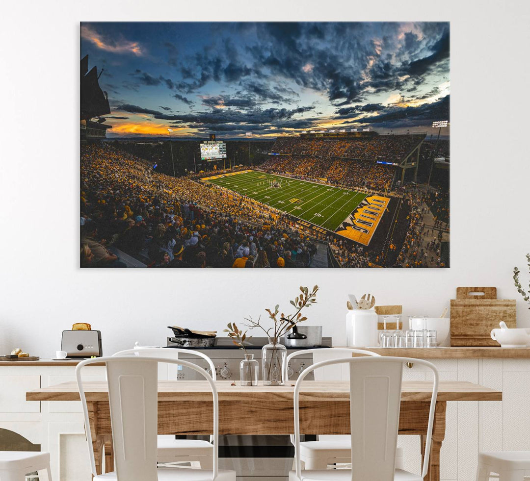 Laramies War Memorial Stadium Print captures a stunning scene of the stadium during sunset, set under a partly cloudy sky illuminated by bright lights.