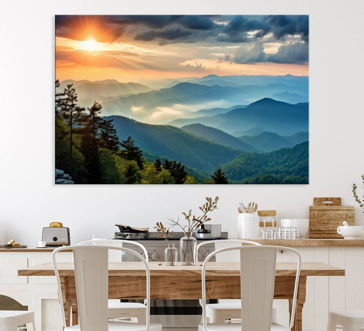 The wall art, titled Sunrise Over Mountain Range, is a canvas print that beautifully depicts layers of hills, scattered trees, and a partly cloudy sky.