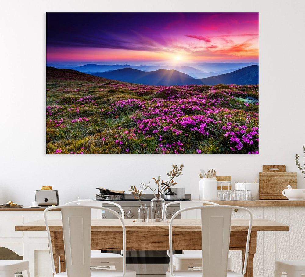 A 3-panel landscape photography canvas of a sunset over mountain meadows with purple wildflowers decorates the wall.