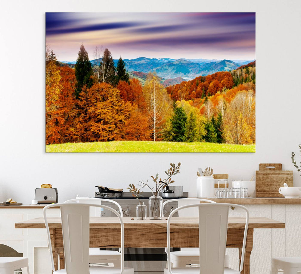 The wall art in the kitchen dining area is a large Autumn Forest Mountain Canvas Print that captures a vivid scenic landscape.